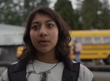 a woman with a bus in the background