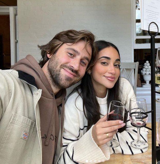 a man and woman holding wine glasses