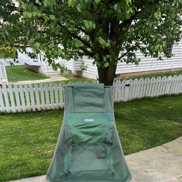 a green folding chair on a patio, helinox chair zero high back