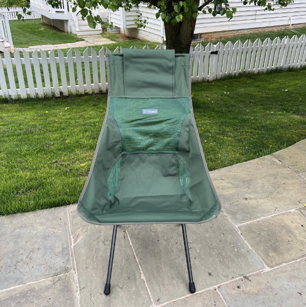 a green folding chair on a patio, helinox chair zero high back