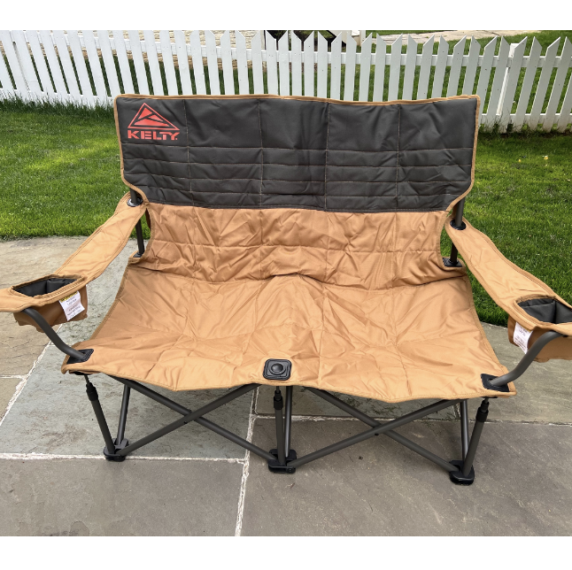 a brown two seater camping chair on the sidewalk, kelty low loveseat