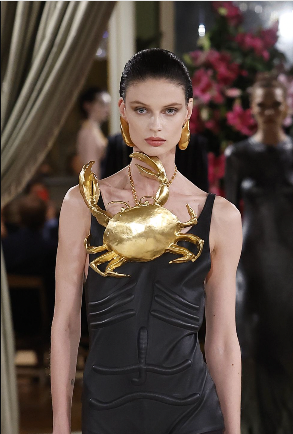 a woman wearing a gold dress