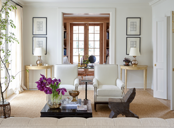 a living room with a couch and chairs