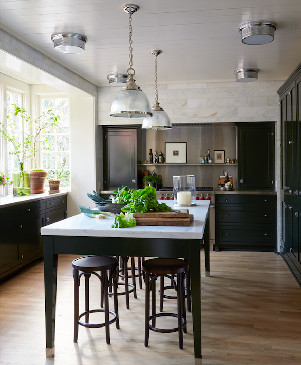 a kitchen with a table and stools