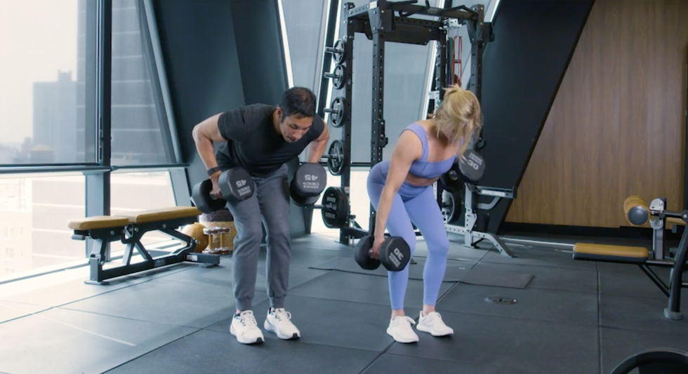a man and a woman working out in a gym