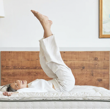 a person doing a handstand on a bed