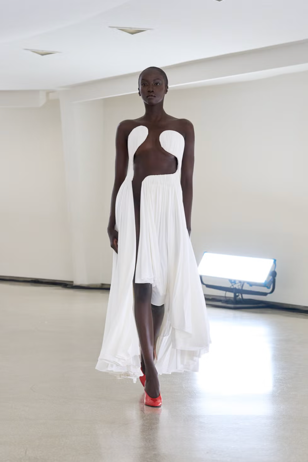 a ﻿cut out accessorized with a dress on either side at the alaia spring summer 2025 show