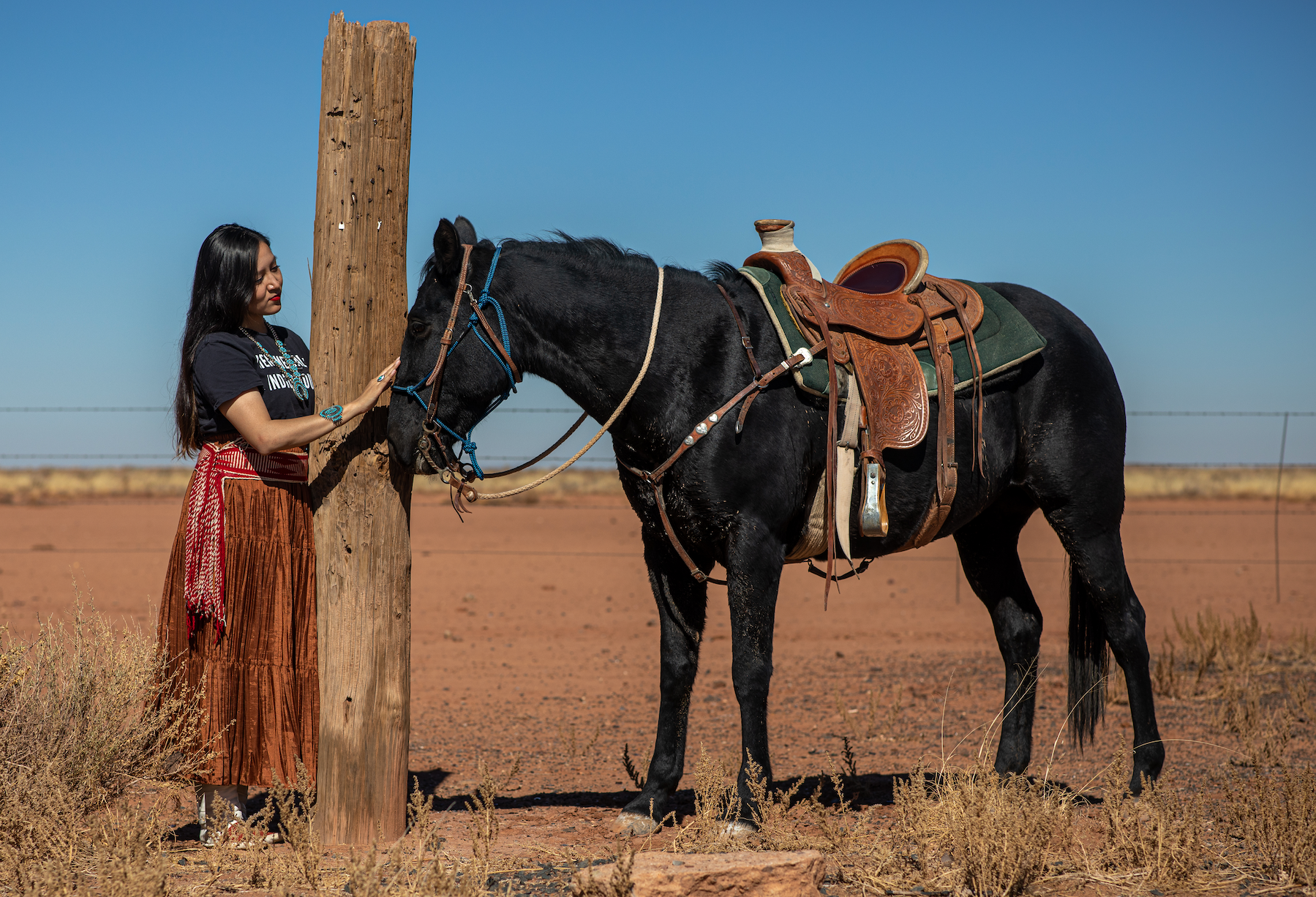 woman petting a horse