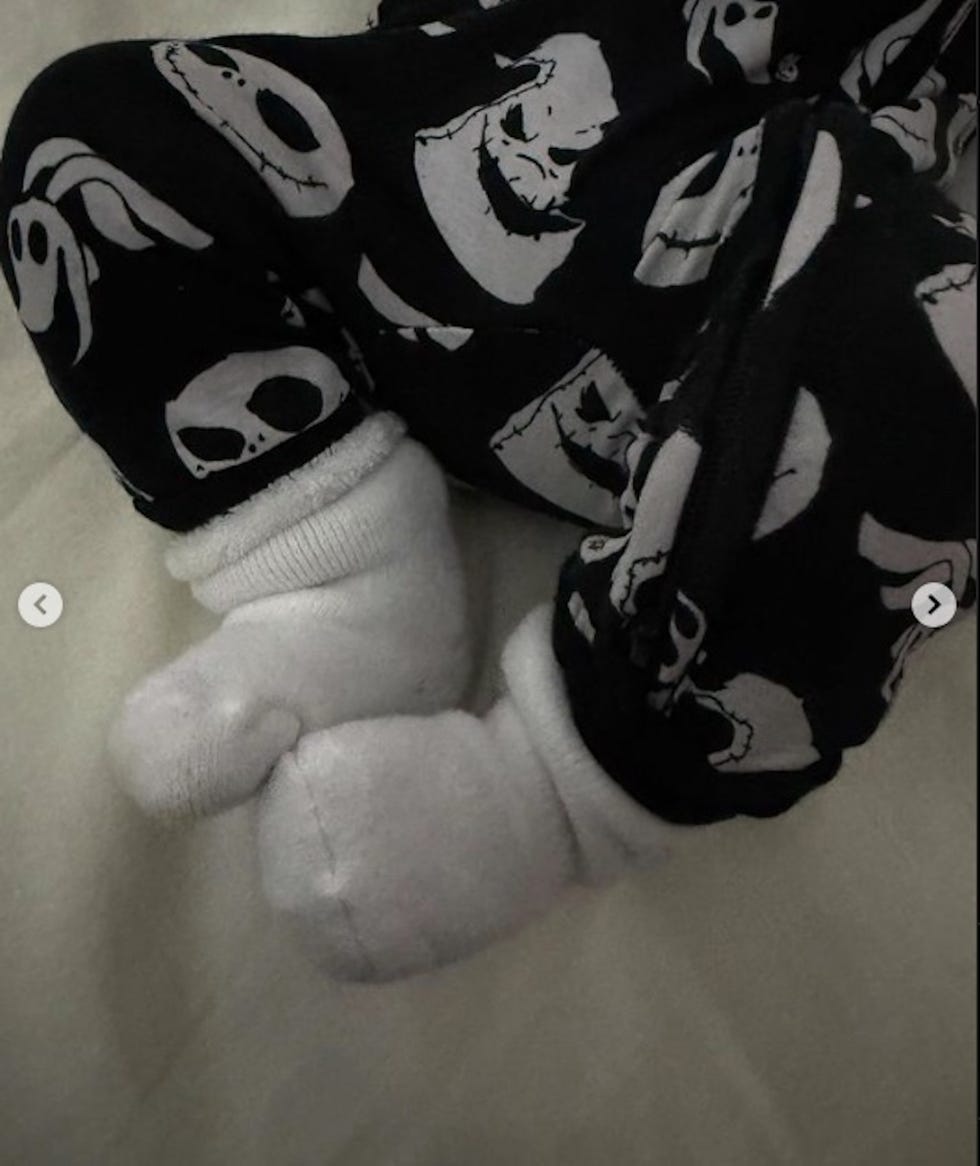 toddlers feet wearing white socks and patterned pants