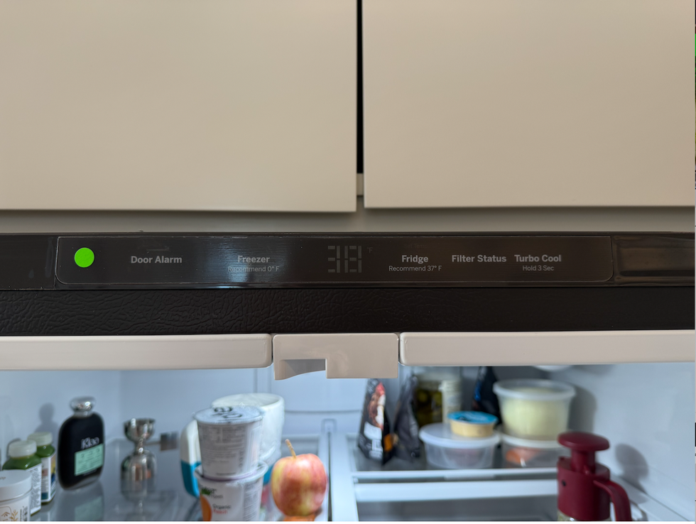 fridge control panel displaying temperature settings and alarms