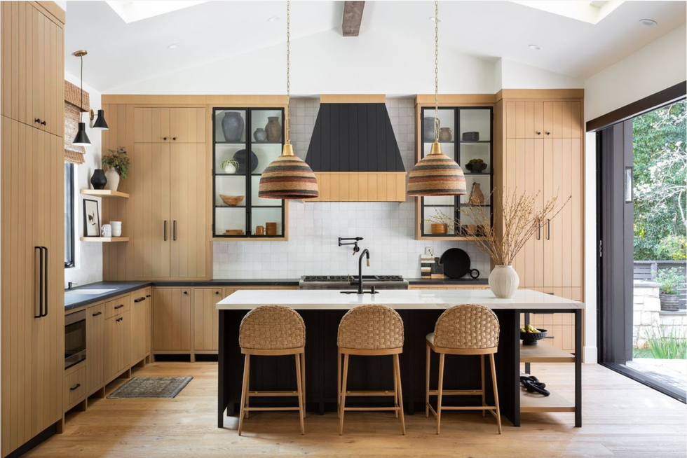 modern kitchen with wood cabinetry and stylish lighting