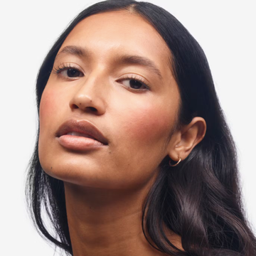 a person with long dark hair is shown from the shoulders up with a neutral expression a person with long dark hair is shown from the shoulders up with a neutral expression