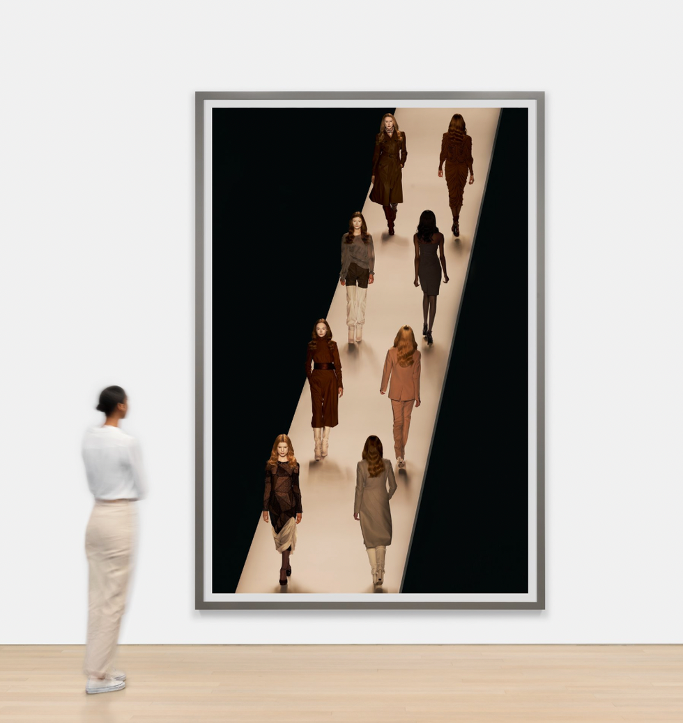 art installation featuring models on a runway depicted in a framed artwork