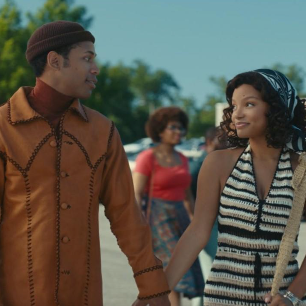 two individuals holding hands dressed in stylish outfits typical of a past era two individuals holding hands dressed in stylish outfits typical of a past era