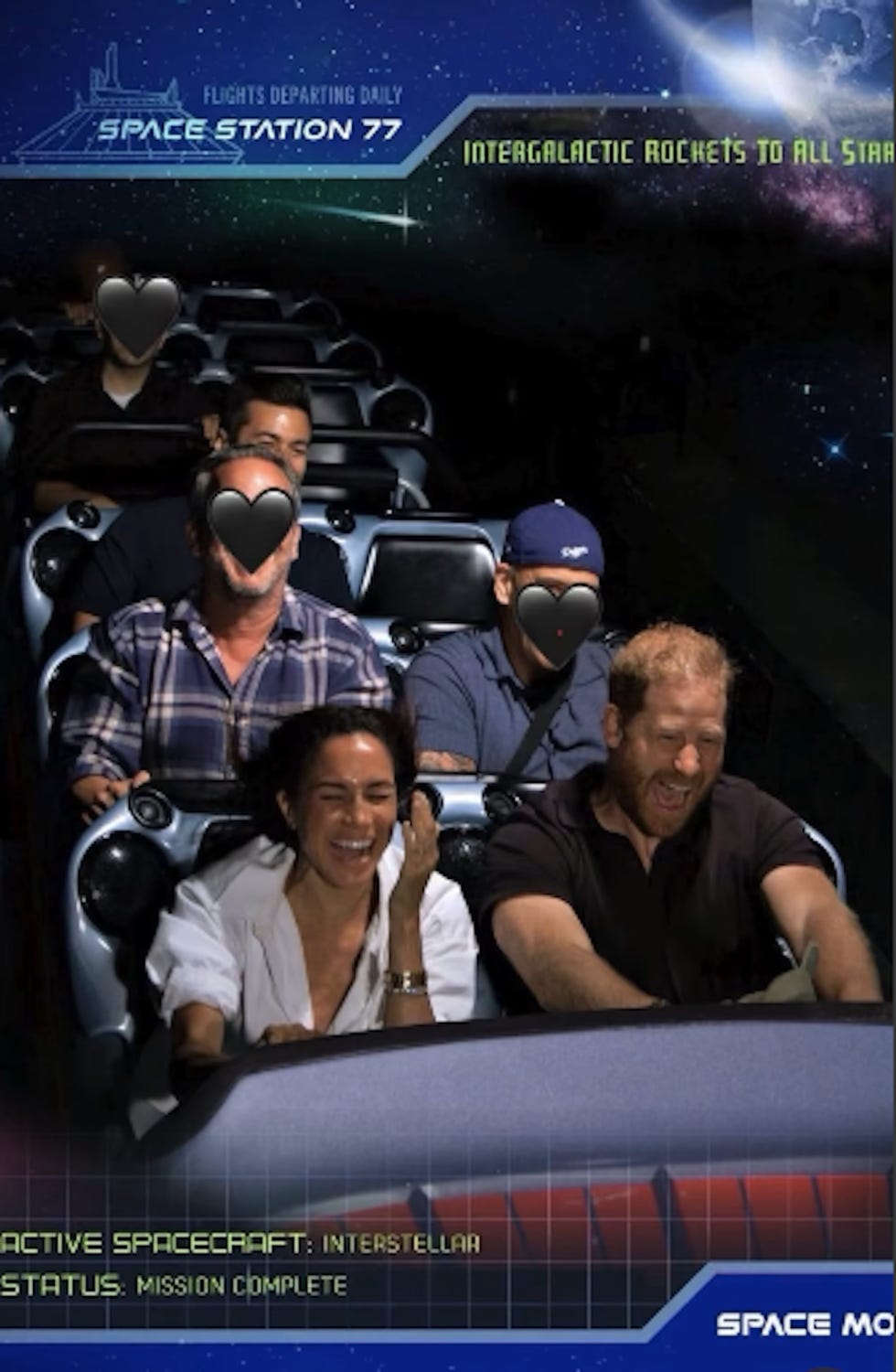 interior of a spacethemed amusement ride with seated passengers