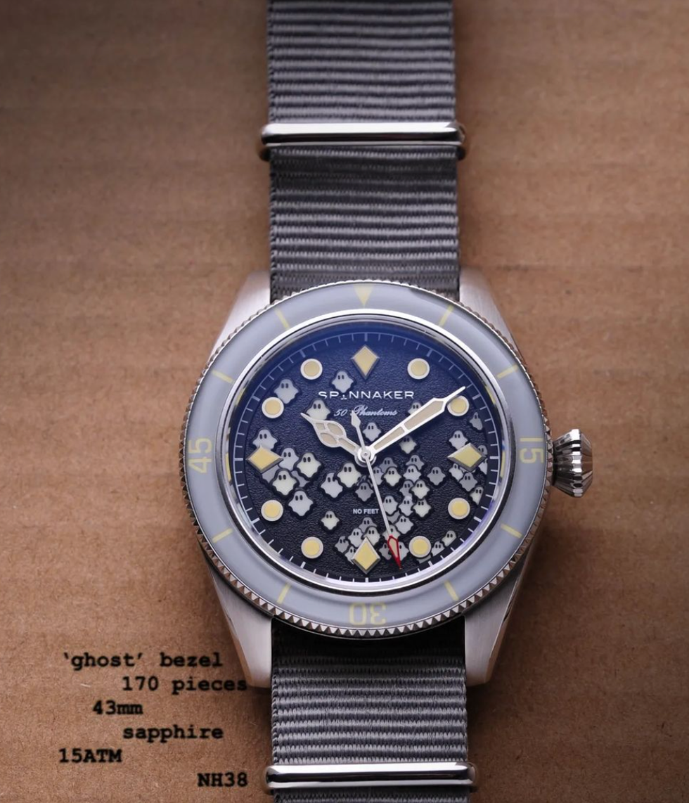 a silver watch with a blue face