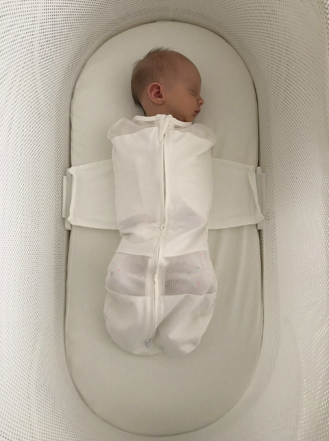 baby sleeping in a snoo bassinet, white bassinet with a sleeping baby, part of the good housekeeping testing for best bassinets
