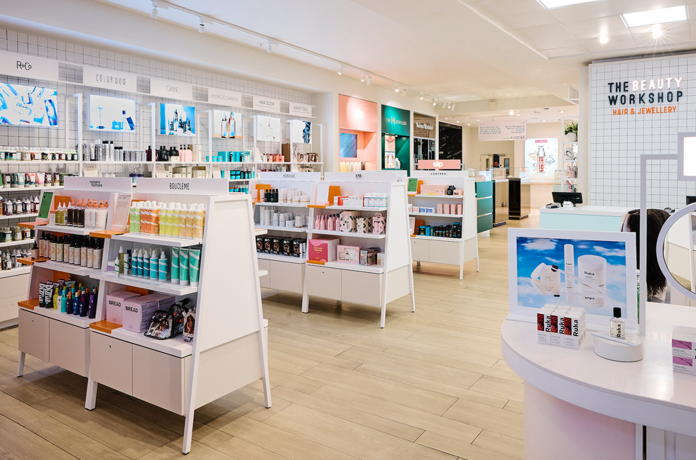 the selfridges expanded hair hall is filled with white shelves packed with products