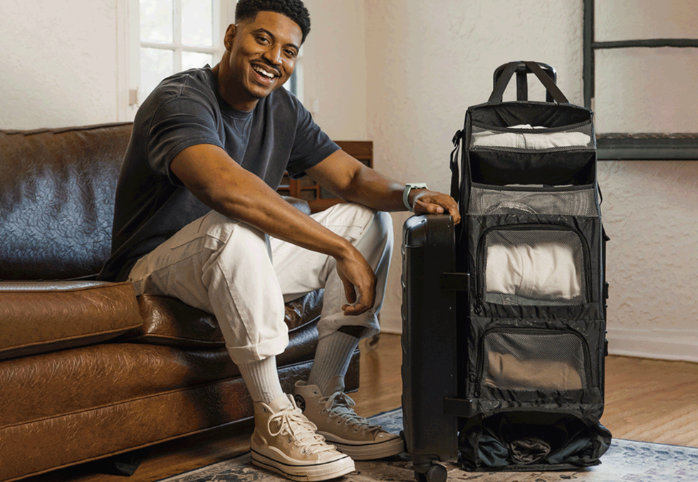 smiling man with solgaard closet carry on suitcase