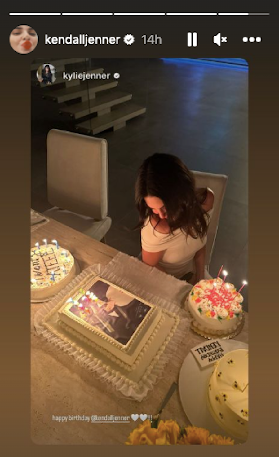 a person sitting at a table with food and candles