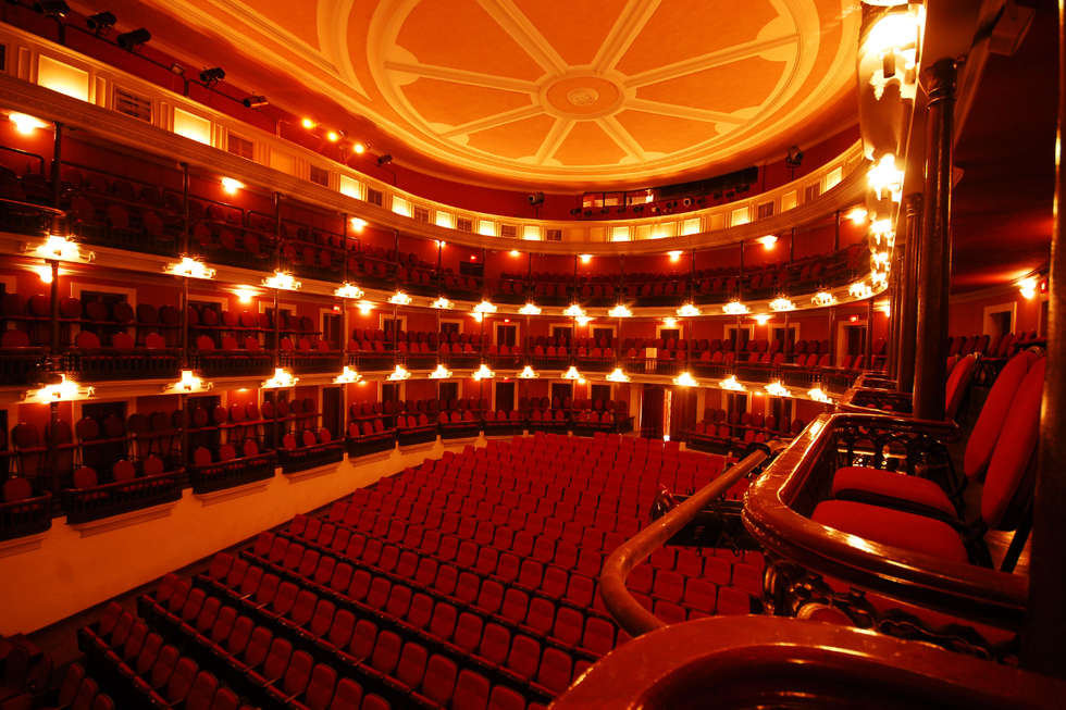 a large theater with red seats