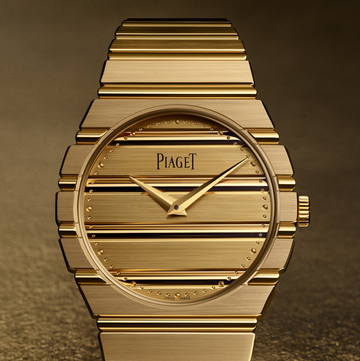 a gold watch with a black face