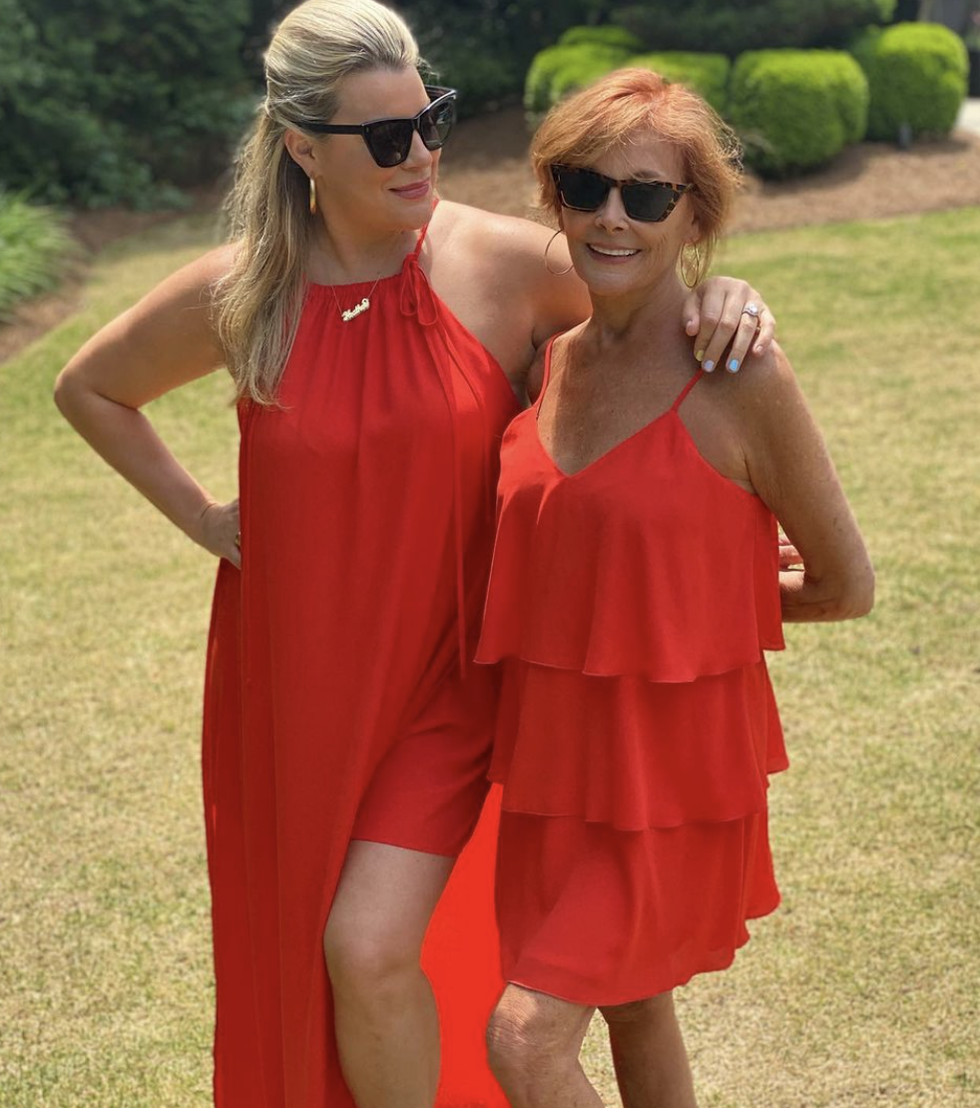 two women wearing red dresses