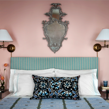 a bed with a blue and white headboard