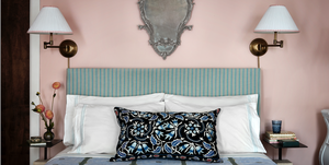 a bed with a blue and white headboard
