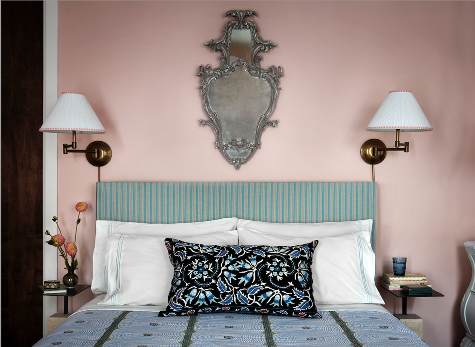 a bed with a blue and white headboard