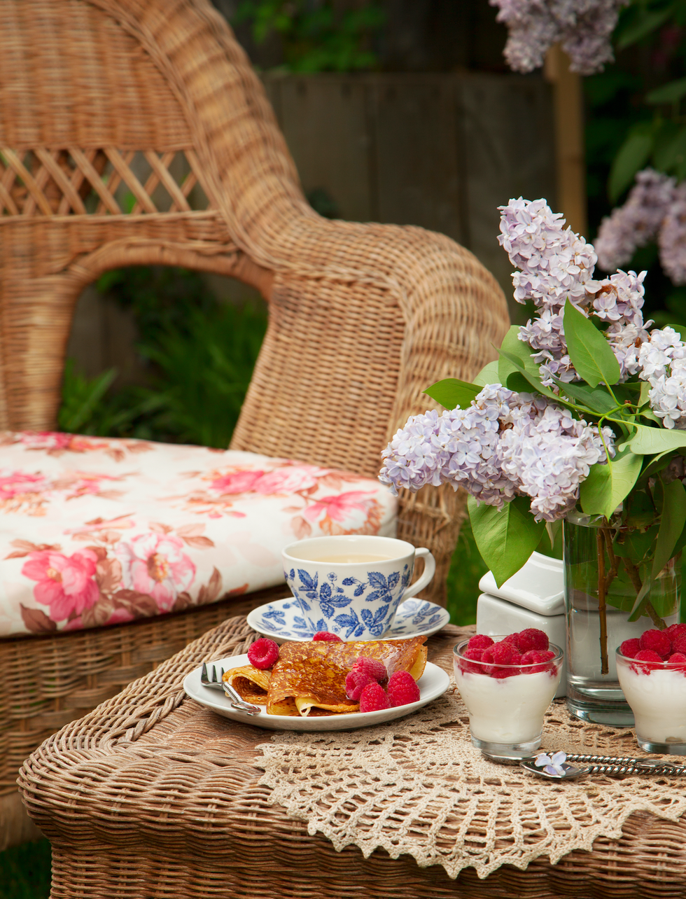 a table with a plate of food and flowers on it