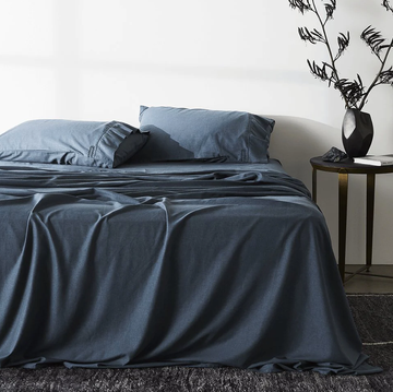 a bed with a blue comforter