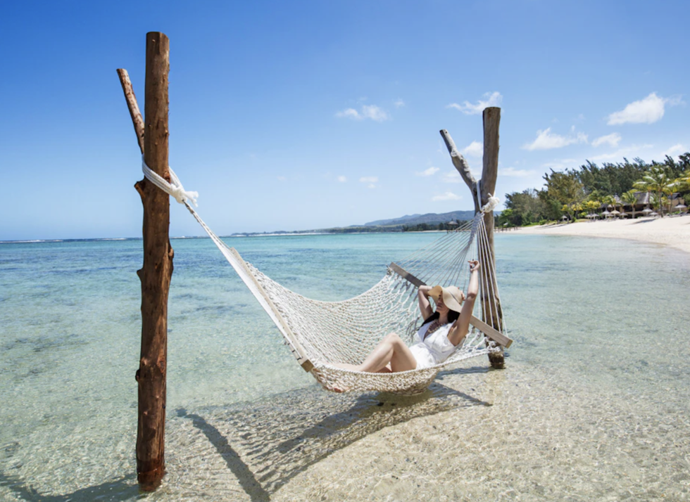 a person lying on a hammock at shanti maurice in mauritius