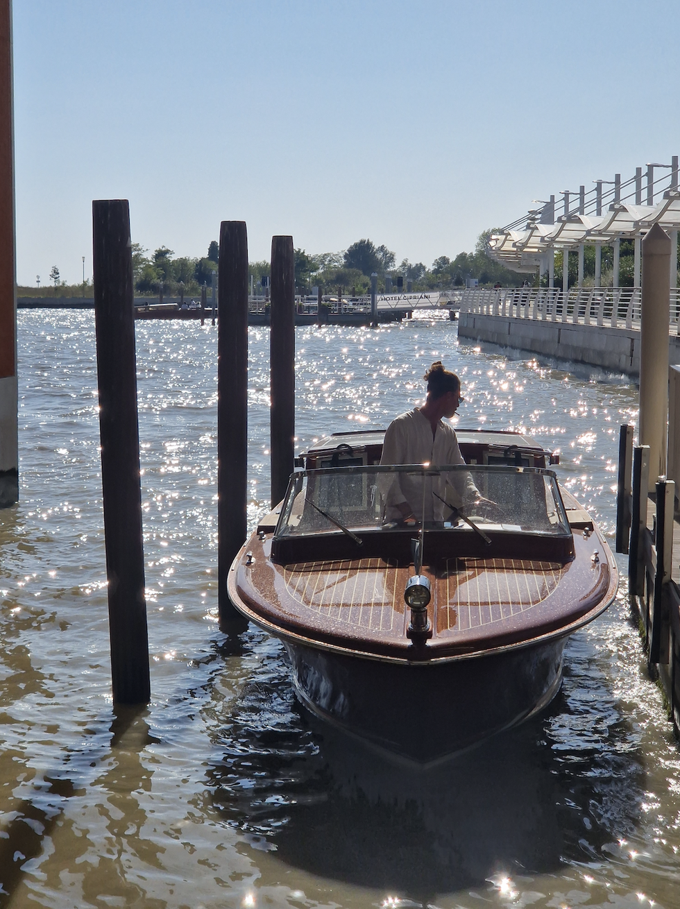 a person in a boat on the water in venice