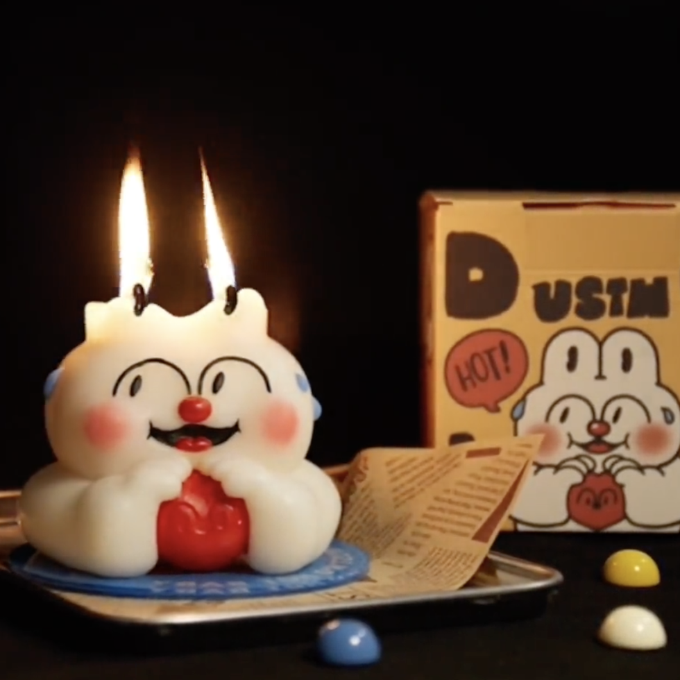 a white cake with a lit candle