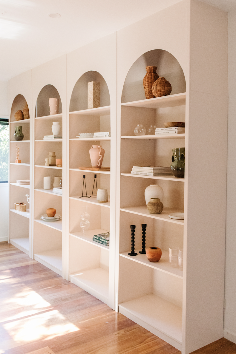 White shelving unit with white shelves and white walls
