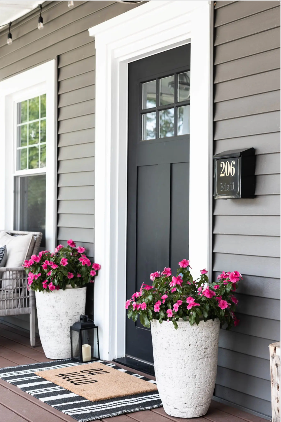 flowers on front porch, black door