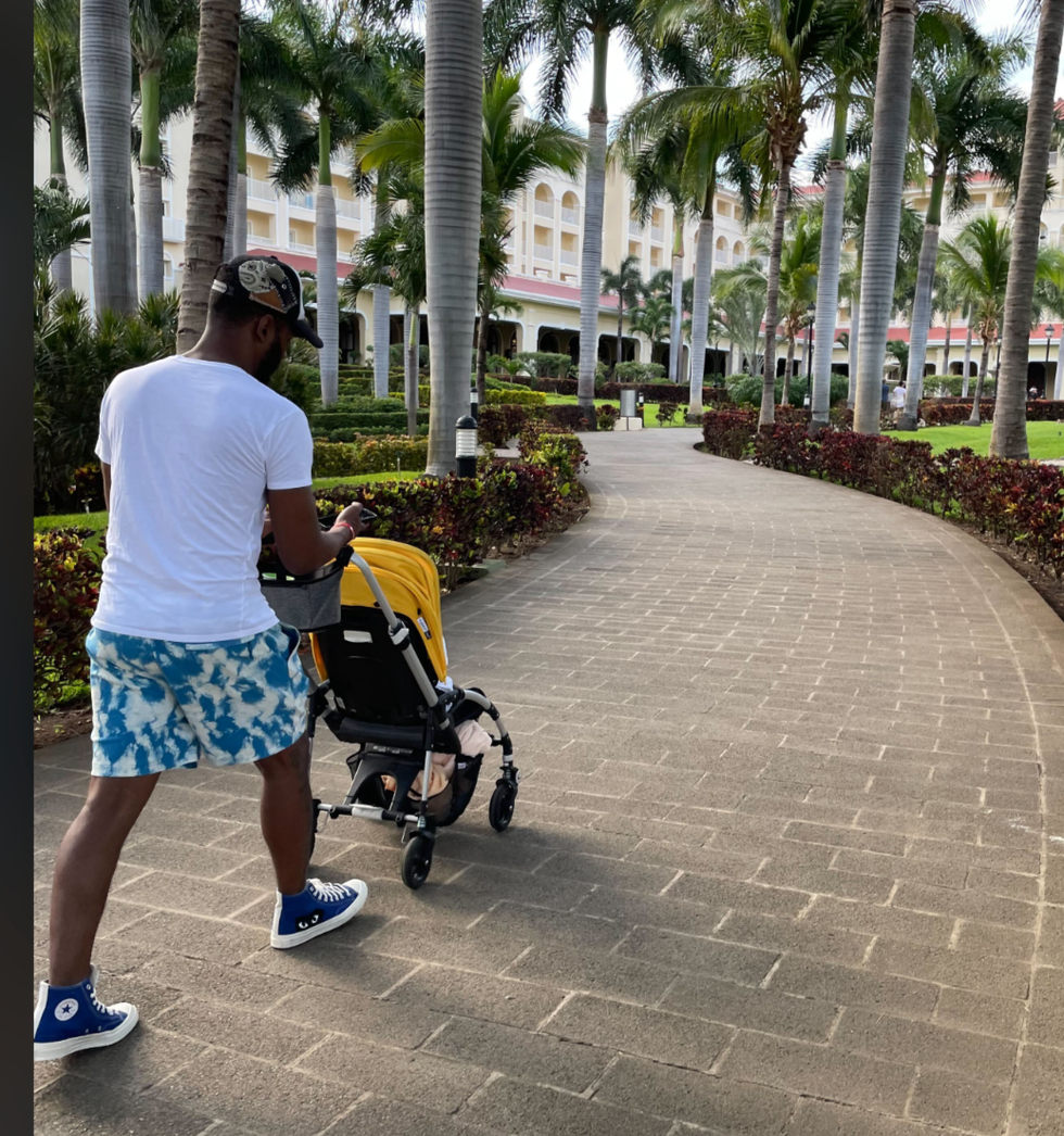 a dad pushes a bugaboo stroller at a resort, part of a good housekeeping story on the best travel strollers