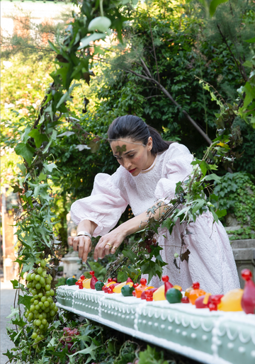 a person arranging fruit in a garden