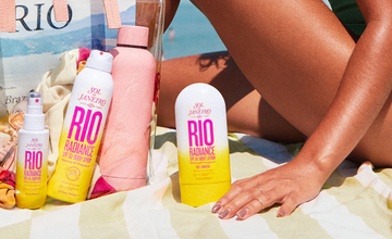a person's feet on a towel next to a couple of bottles