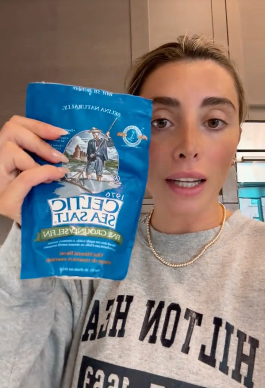 a person holding a blue can
