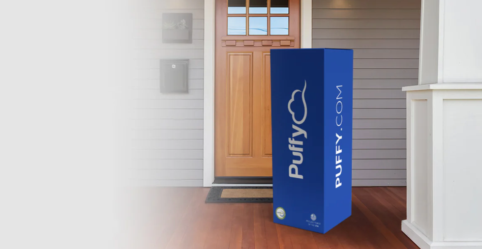 a blue puffy mattress box on a front porch