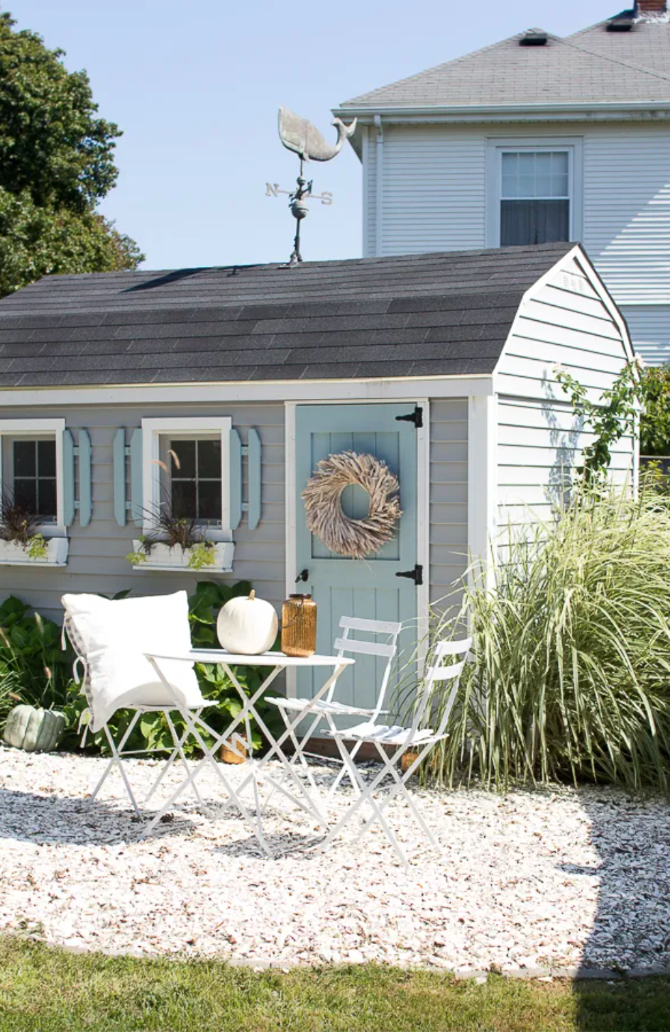 a house with a patio and a table and chairs in the front