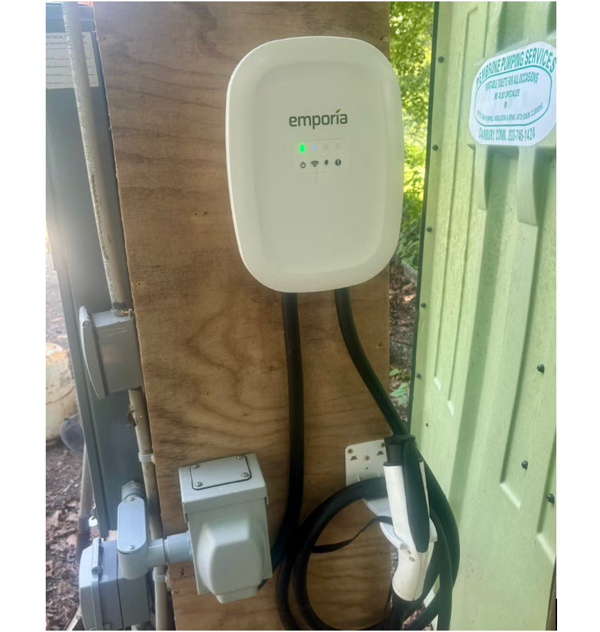 a white ev home charging device mounted to a wall