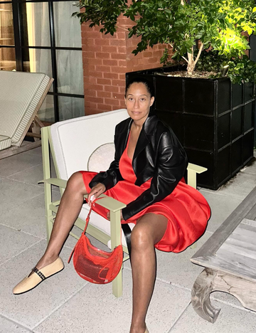 tracee ellis ross in a red dress and mesh alaïa bag on july 19, 2024