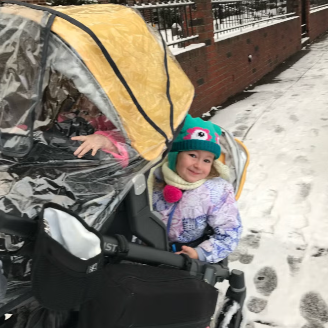 GH testing of double strollers a baby in a double stroller on a snowy sidewalk