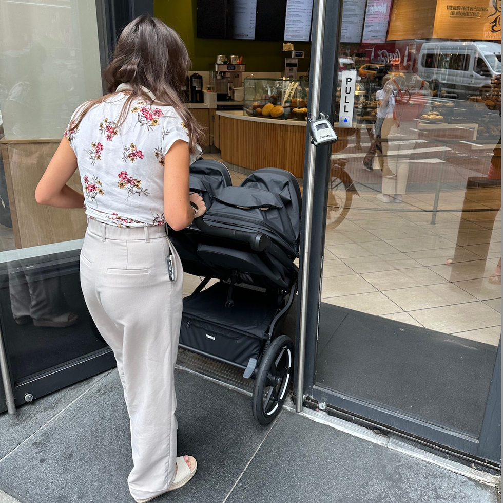 fitting a side by side double stroller through a door a tester from the good housekeeping institute pushes a double stroller from thule through the door of a panera restaurant
