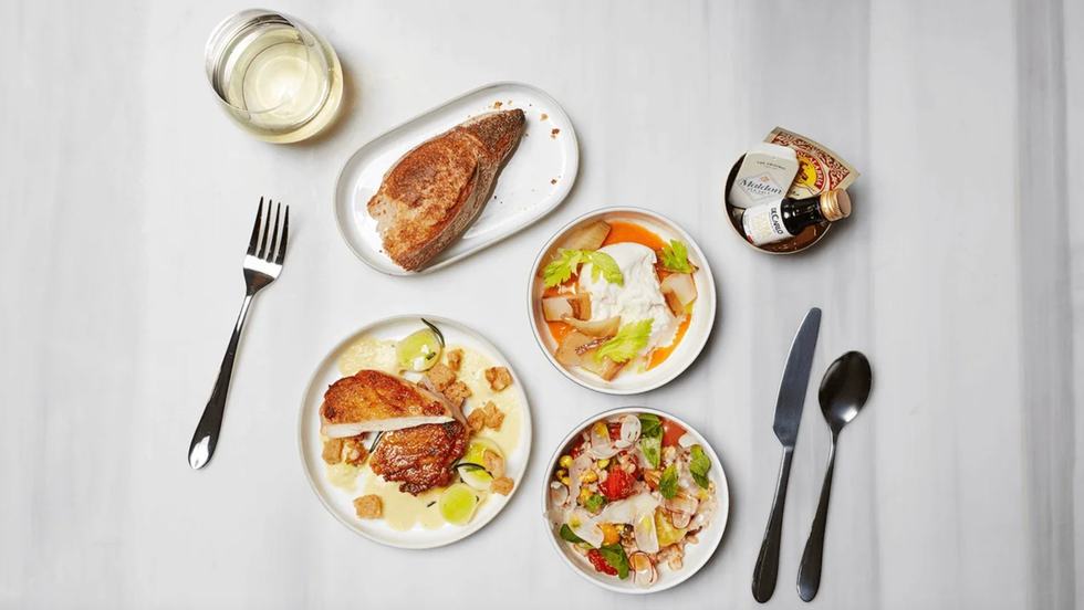 a table with plates of food and silverware