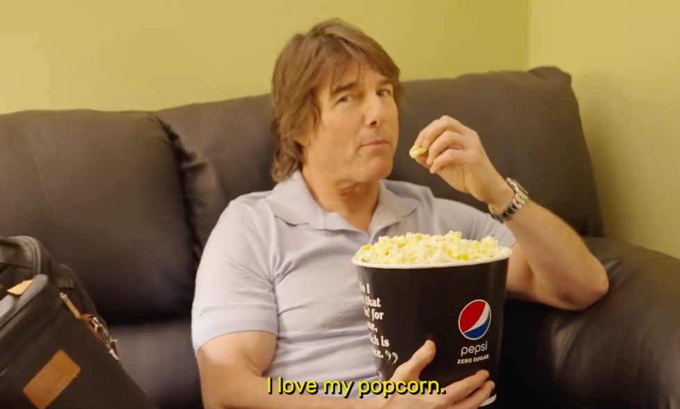 a woman sitting on a couch with a plate of food