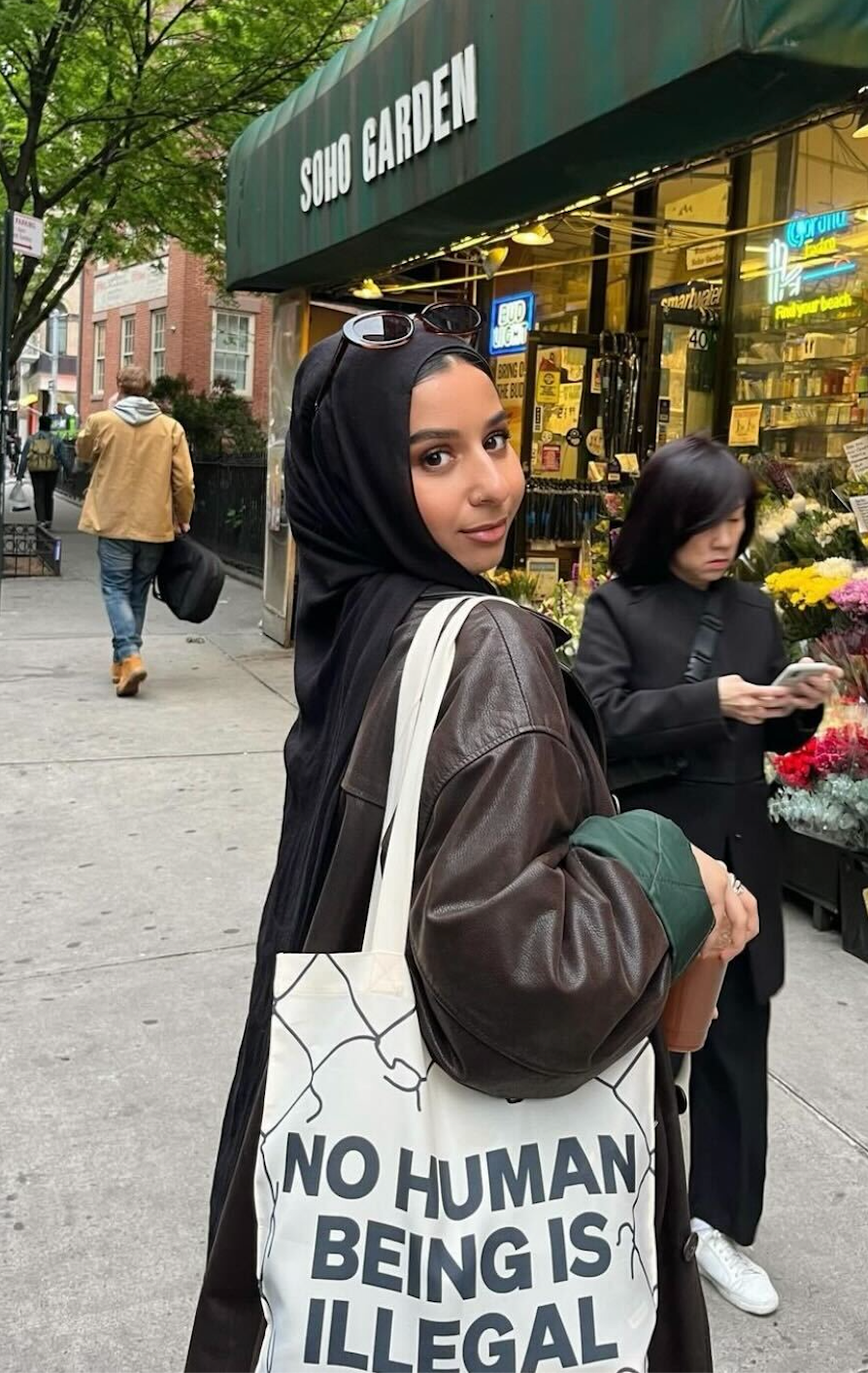 furvah shah carries a tote bag which says no human being is illegal